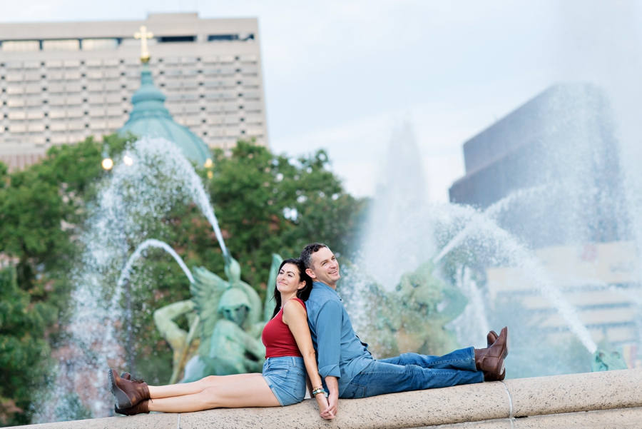 A couple relax at the fountain in Logan Circle in Philly.